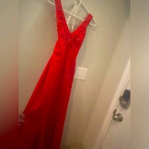 Beautiful red with beaded details formal dress. Also has a train in the back